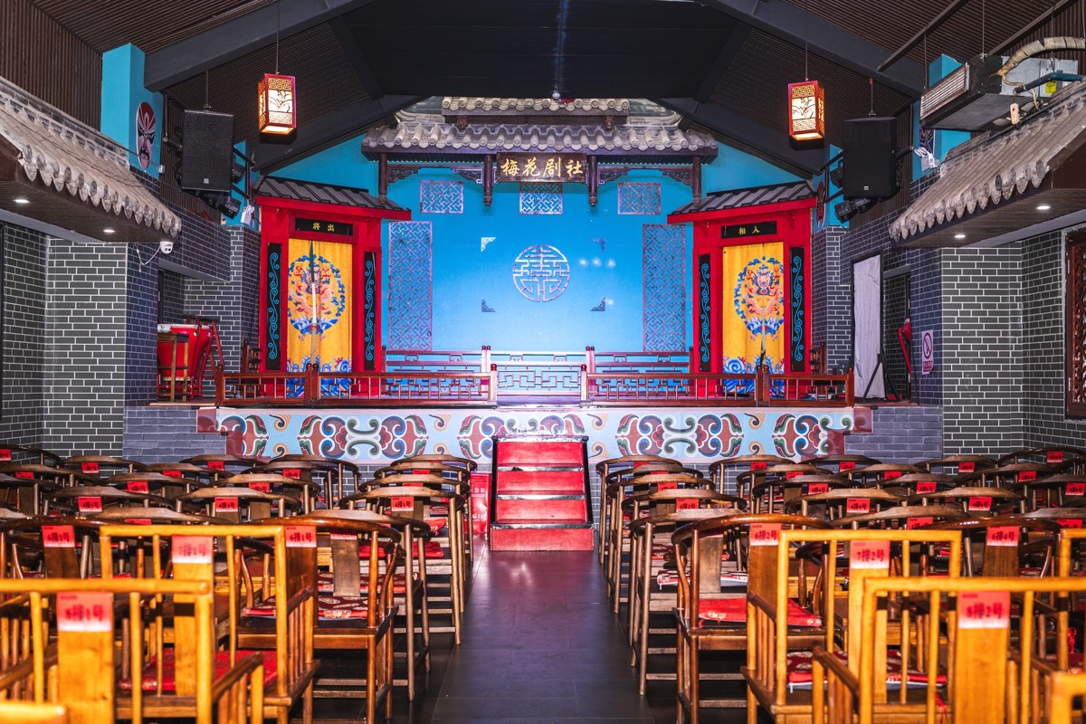 Lanterns and painted panels around the stage of a Sichuan opera theatre in Chengdu